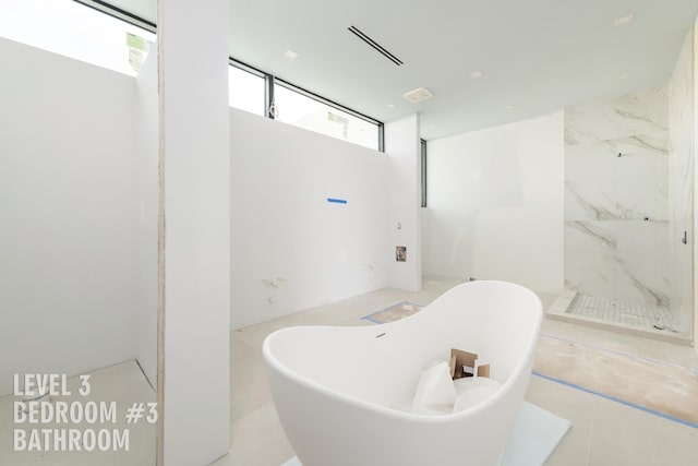 bathroom featuring shower with separate bathtub