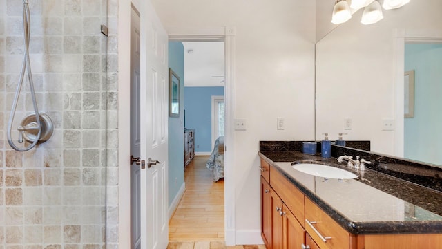 bathroom featuring vanity, wood-type flooring, and walk in shower