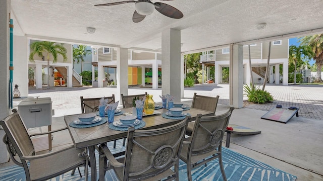 sunroom featuring ceiling fan