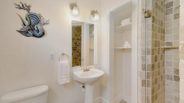 bathroom featuring sink, toilet, and walk in shower