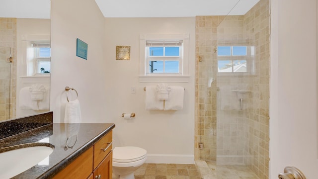 bathroom featuring vanity, an enclosed shower, and toilet