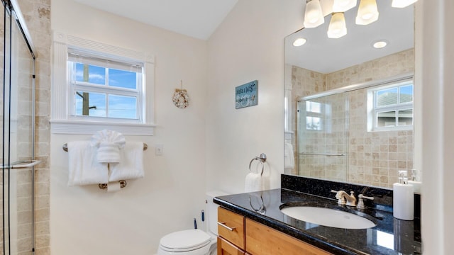 bathroom with vanity, toilet, and walk in shower