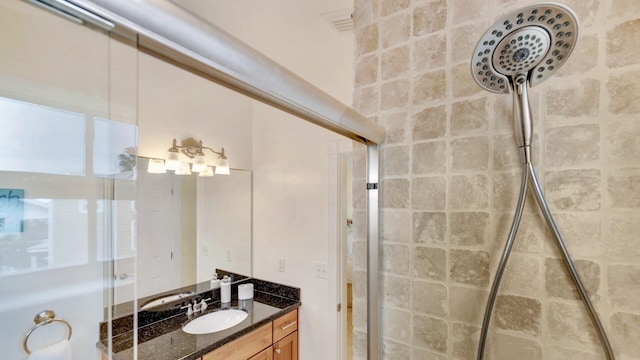 bathroom featuring vanity and an enclosed shower