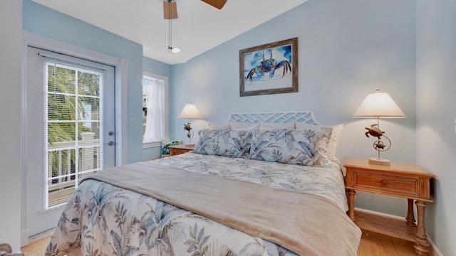 bedroom featuring access to outside, vaulted ceiling, ceiling fan, and light wood-type flooring