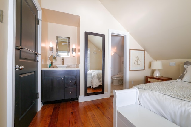 1414 Angela St, Key West, FL 33040 - bedroom with vaulted ceiling, a sink, dark wood-style floors, and connected bathroom