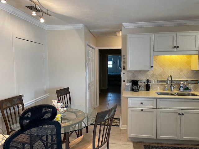 kitchen with white cabinets, visible vents, light countertops, and a sink