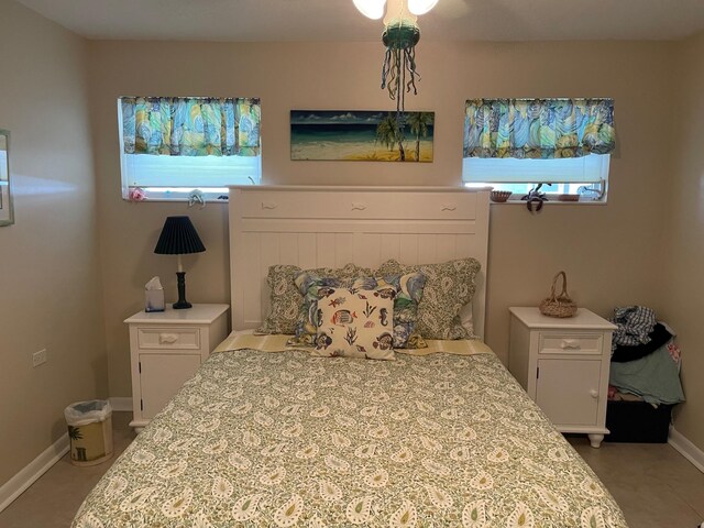 bedroom featuring multiple windows and baseboards