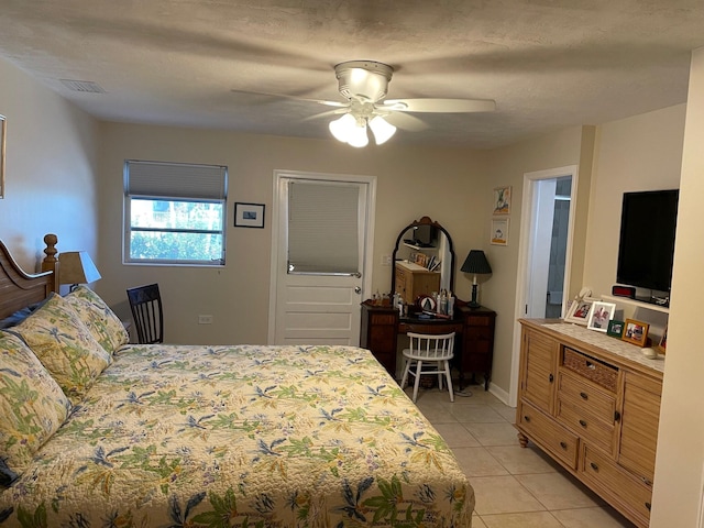 bedroom with ceiling fan, visible vents, a textured ceiling, and light tile patterned flooring