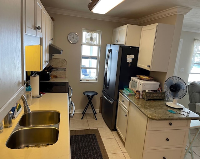 kitchen featuring light countertops, white microwave, white cabinetry, a sink, and extractor fan