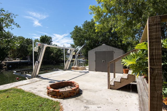 view of patio / terrace featuring a storage unit and an outdoor fire pit