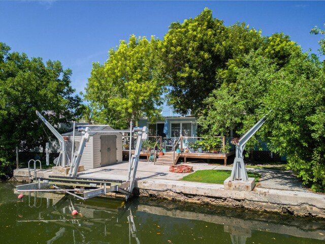 back of property with a deck with water view