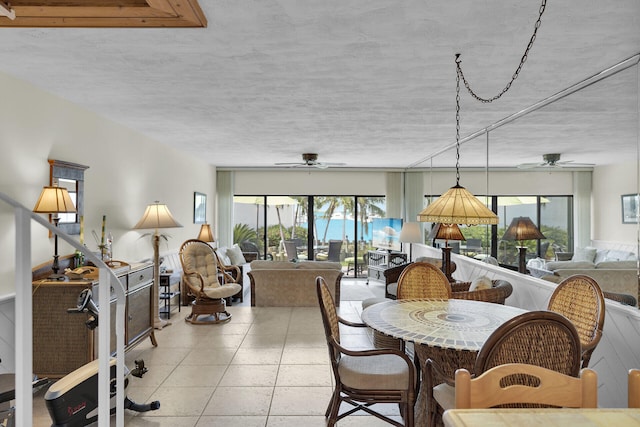 dining room with a textured ceiling and ceiling fan