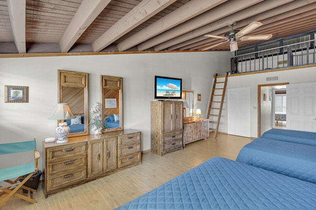 bedroom with vaulted ceiling with beams and light hardwood / wood-style flooring