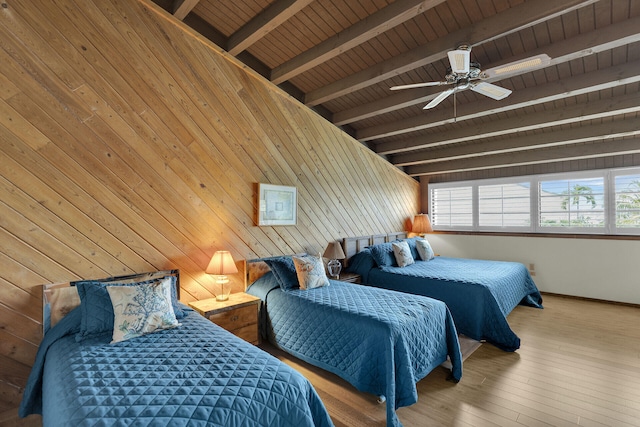 bedroom with wood ceiling, wooden walls, ceiling fan, beam ceiling, and hardwood / wood-style floors