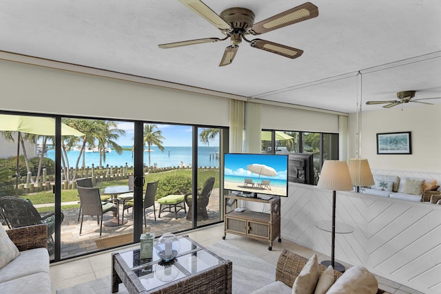 tiled living room featuring ceiling fan