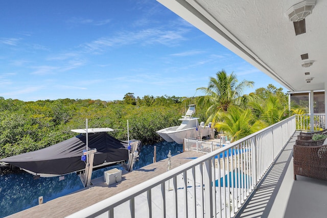 balcony with a dock and a water view