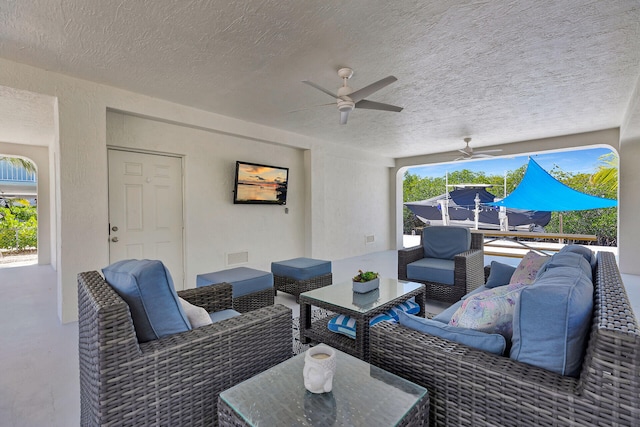 view of patio with an outdoor living space, visible vents, and ceiling fan