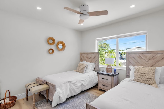 bedroom featuring recessed lighting, light wood-style flooring, a ceiling fan, and baseboards