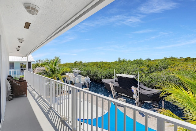 balcony with a dock and a water view