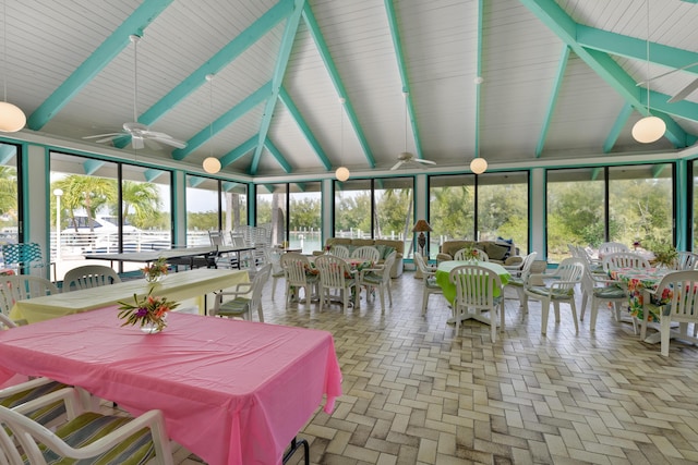 sunroom featuring lofted ceiling with beams