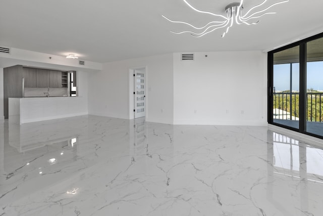 unfurnished room with visible vents, floor to ceiling windows, marble finish floor, and baseboards