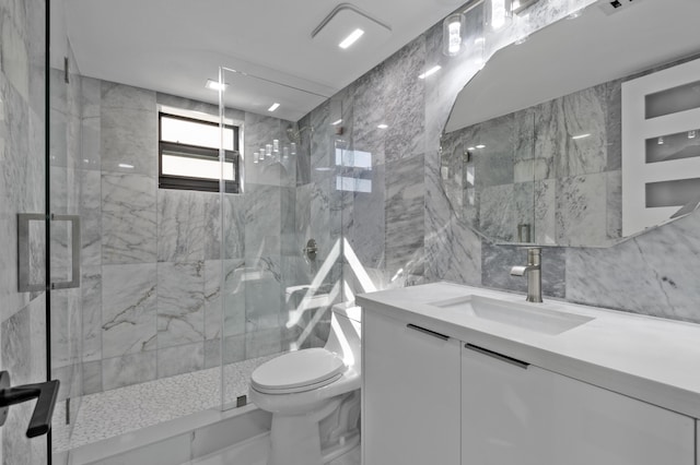 bathroom with a marble finish shower, toilet, and vanity