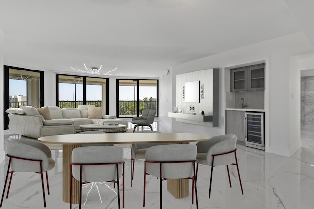 dining space with beverage cooler, marble finish floor, and indoor wet bar