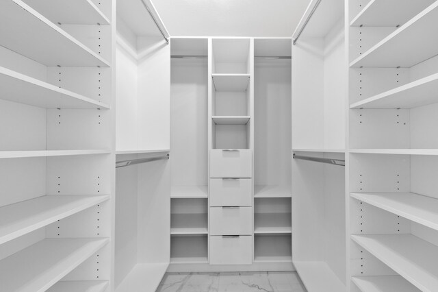 spacious closet with marble finish floor