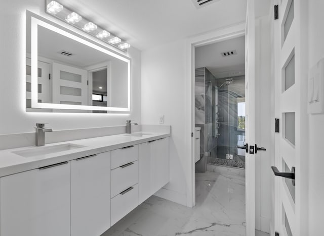 bathroom with a stall shower, visible vents, marble finish floor, and a sink