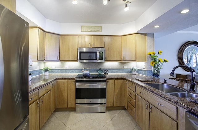 96000 Overseas Hwy Unit X54, Key Largo, FL 33037 - kitchen featuring stainless steel appliances, a sink, light tile patterned flooring, dark stone countertops, and a peninsula