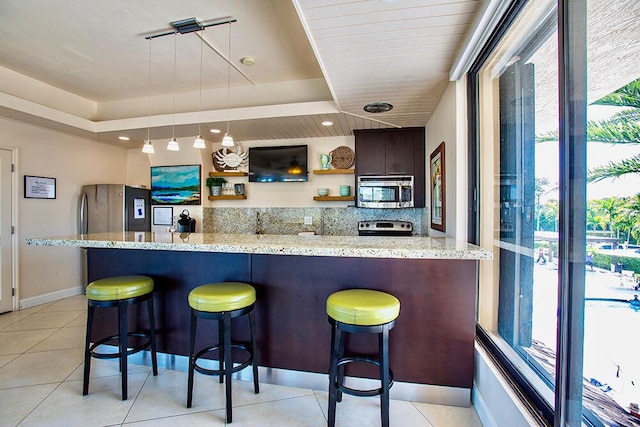 96000 Overseas Hwy Unit X54, Key Largo, FL 33037 - kitchen featuring stainless steel appliances, healthy amount of natural light, open shelves, and a kitchen bar