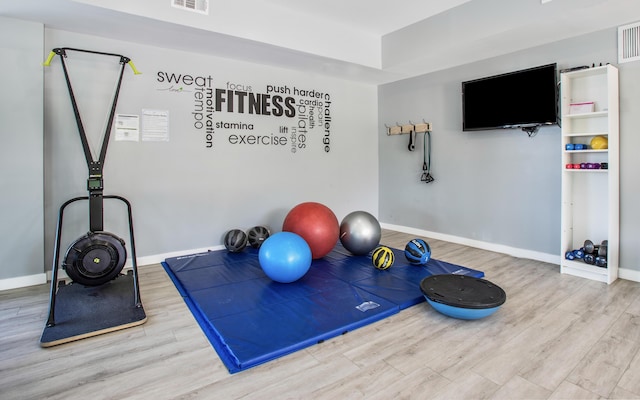 96000 Overseas Hwy Unit X54, Key Largo, FL 33037 - workout room featuring wood finished floors and baseboards
