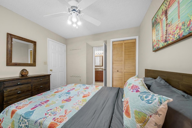 bedroom with a textured ceiling, a closet, ensuite bath, and a ceiling fan