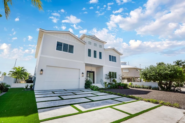 contemporary house featuring a garage and a front yard