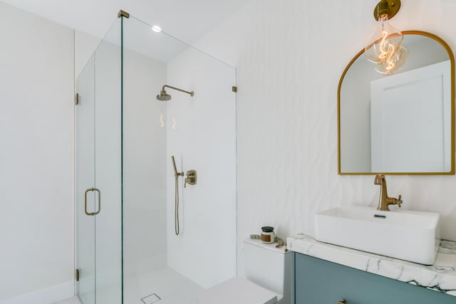 bathroom featuring vanity and a shower with door