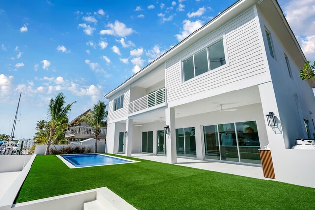 back of house featuring ceiling fan, a yard, and a patio