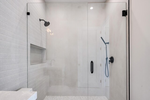 bathroom with a shower with door