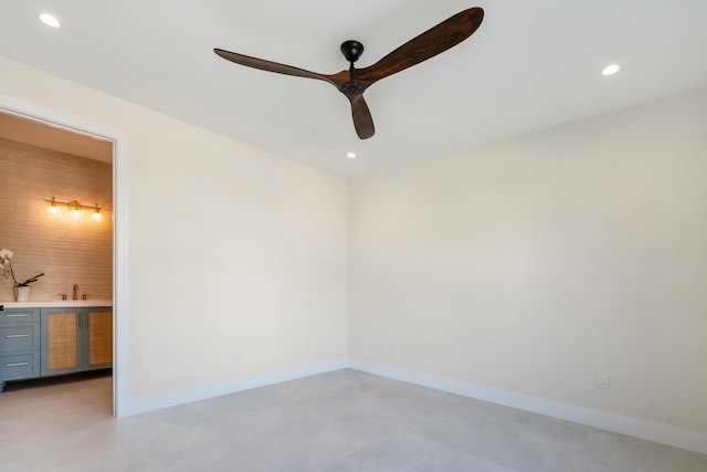 unfurnished room with ceiling fan and sink