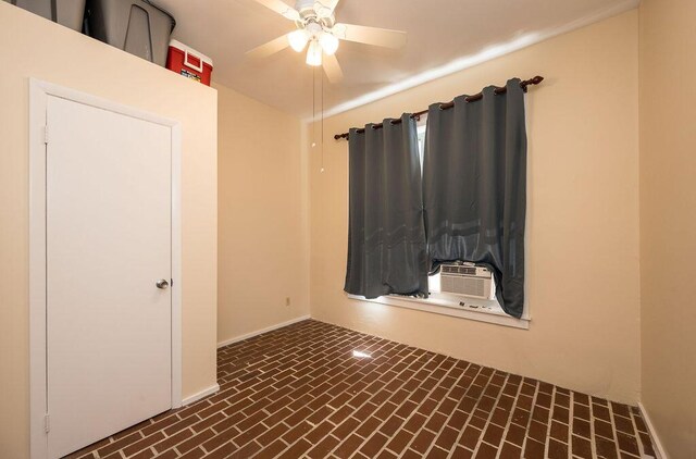 empty room featuring cooling unit and ceiling fan