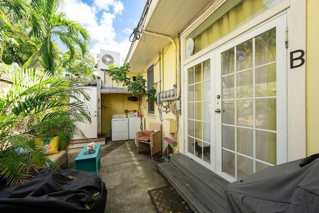 view of patio / terrace featuring french doors and separate washer and dryer