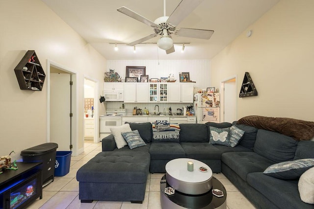 living room with ceiling fan, rail lighting, and light tile patterned floors