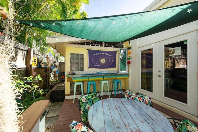 deck featuring a bar and french doors