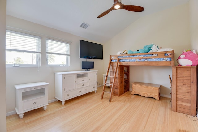 bedroom with a ceiling fan, vaulted ceiling, light wood-type flooring, and visible vents