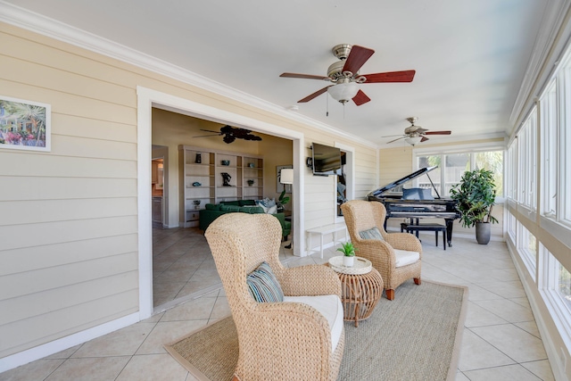 sunroom / solarium featuring ceiling fan