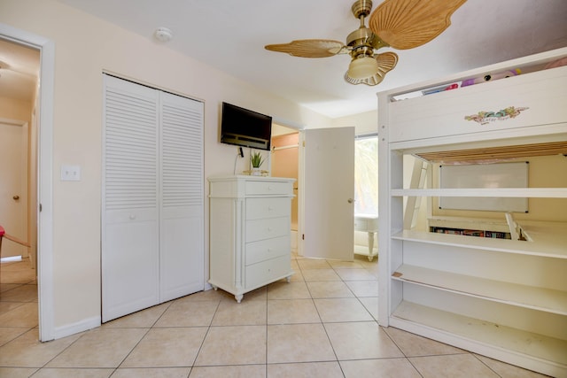 unfurnished bedroom with a closet, ceiling fan, and light tile patterned floors