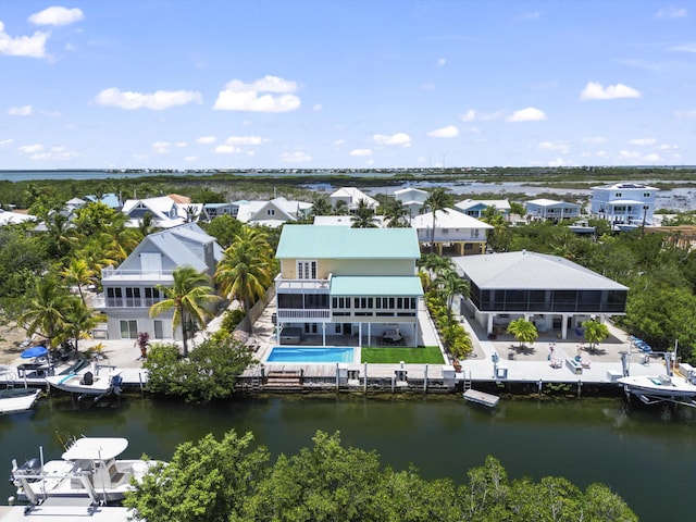 drone / aerial view featuring a residential view and a water view