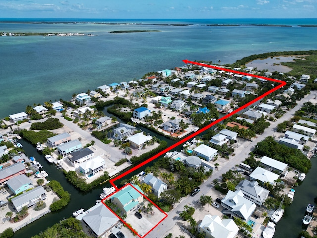 birds eye view of property with a water view and a residential view