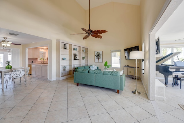 living area featuring visible vents, plenty of natural light, and ceiling fan