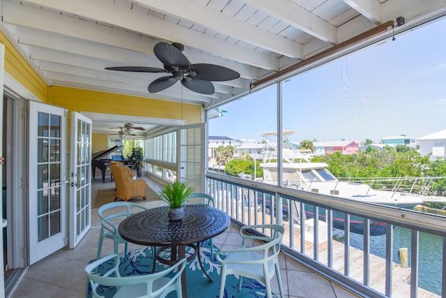 balcony with french doors and a ceiling fan