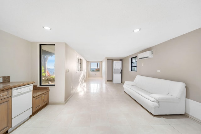 living room featuring light tile patterned floors and an AC wall unit